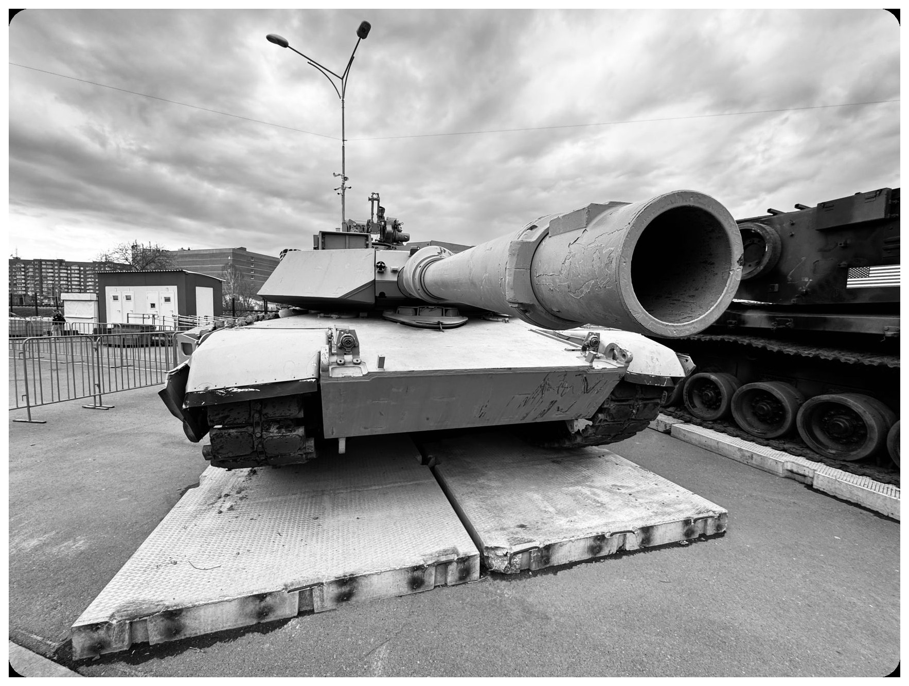 military equipment display, tanks and defense systems, european flags, industrial manufacturing facility