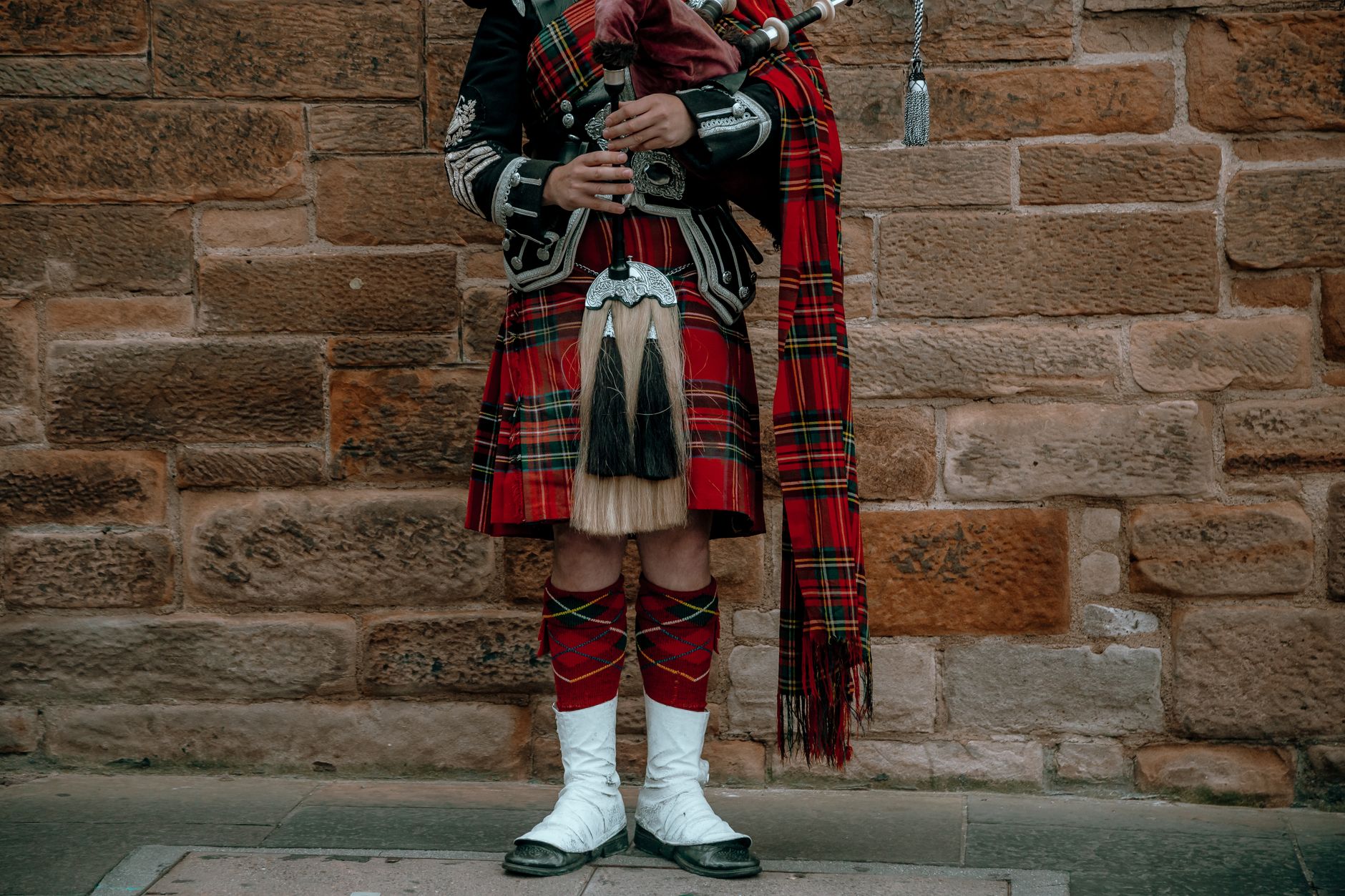 scottish bagpipes gaita players celtic festival colorful traditional costumes crowd parade medieval atmosphere