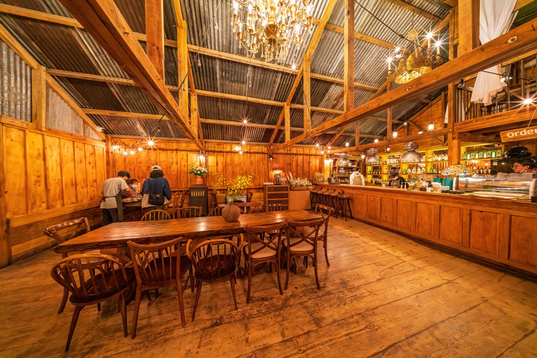 cozy traditional spanish restaurant interior with wooden beams rustic decorations warm candlelight diners enjoying authentic regional dishes