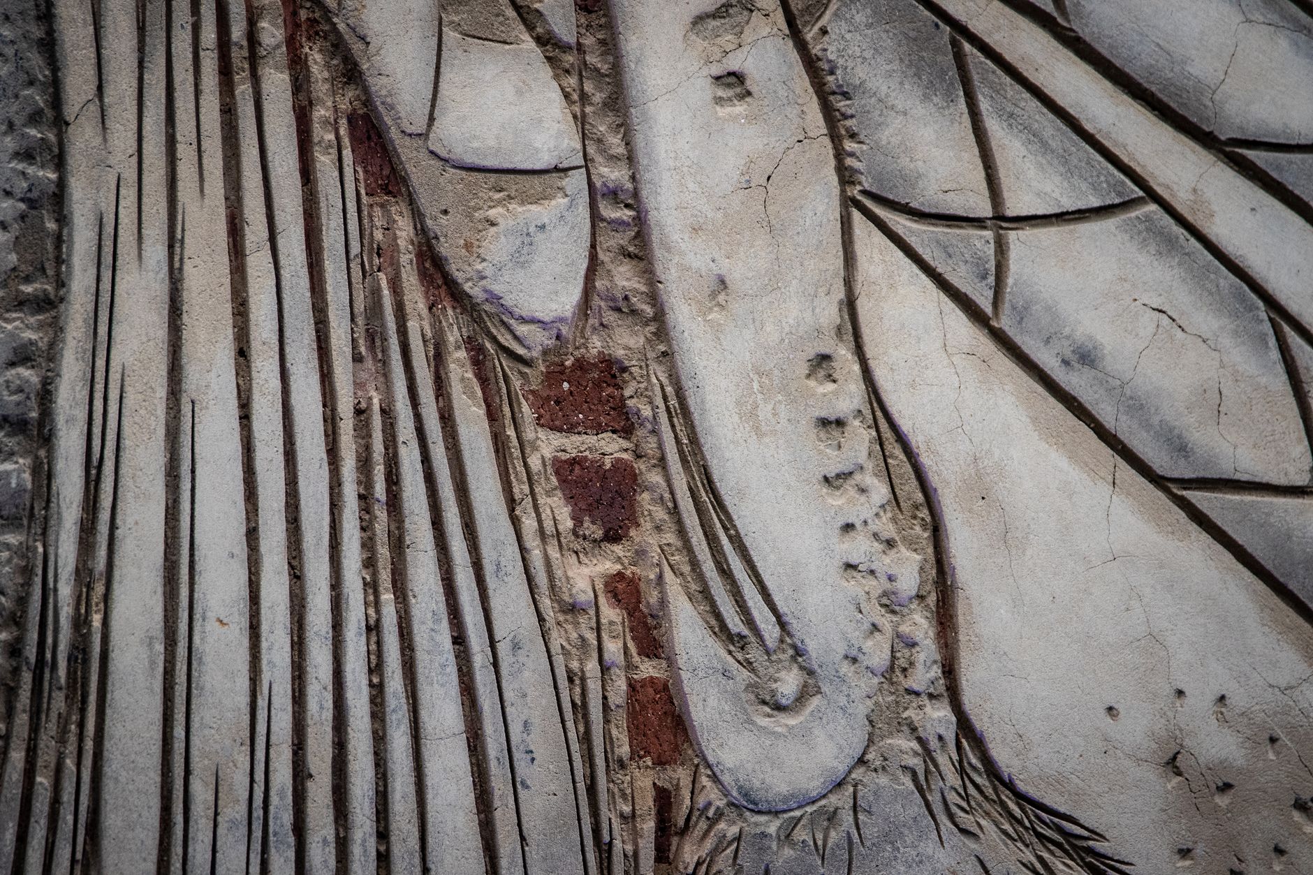 close up weathered stone carving andalusi ornamentation on historic mosque door cracks and lichen texture