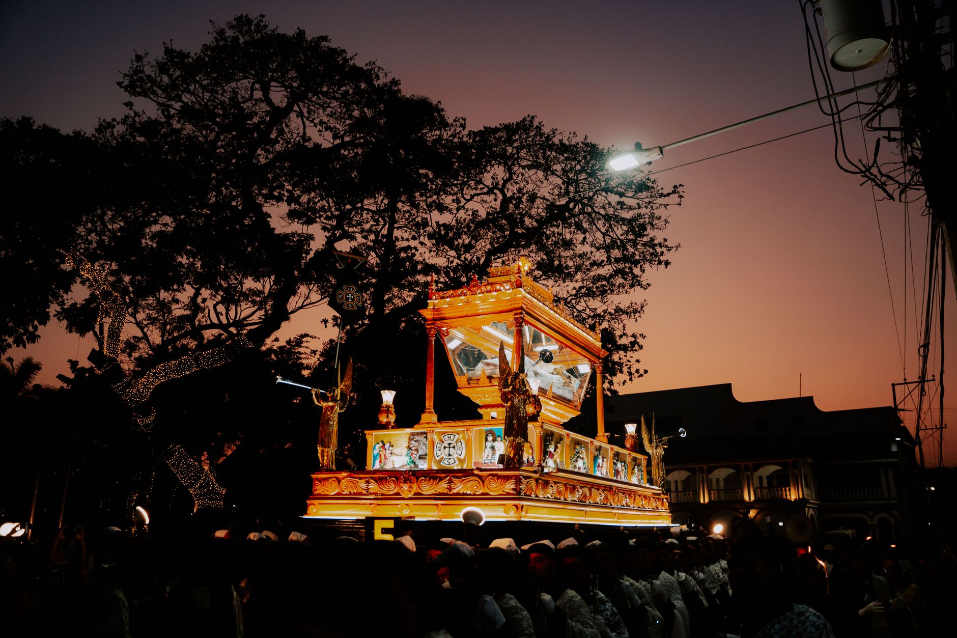 open coffin procession through narrow village streets in Galicia with devotees in ceremonial robes carrying coffins during Santa Marta festival dramatic sacred ritual