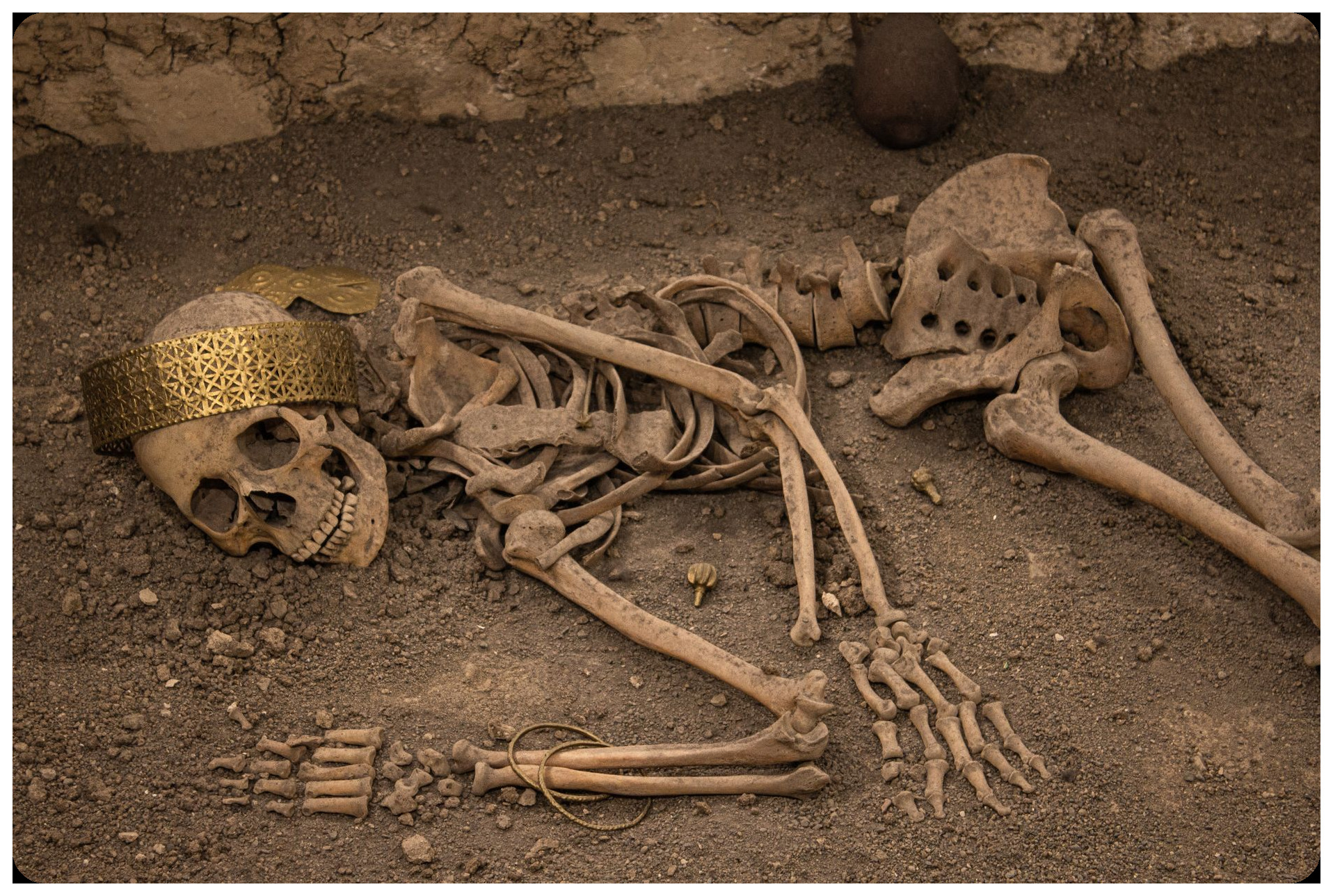 ancient roman tomb excavation in Valencia street, burial urns and artifacts emerging from earth, archaeological site with modern buildings in background daylight