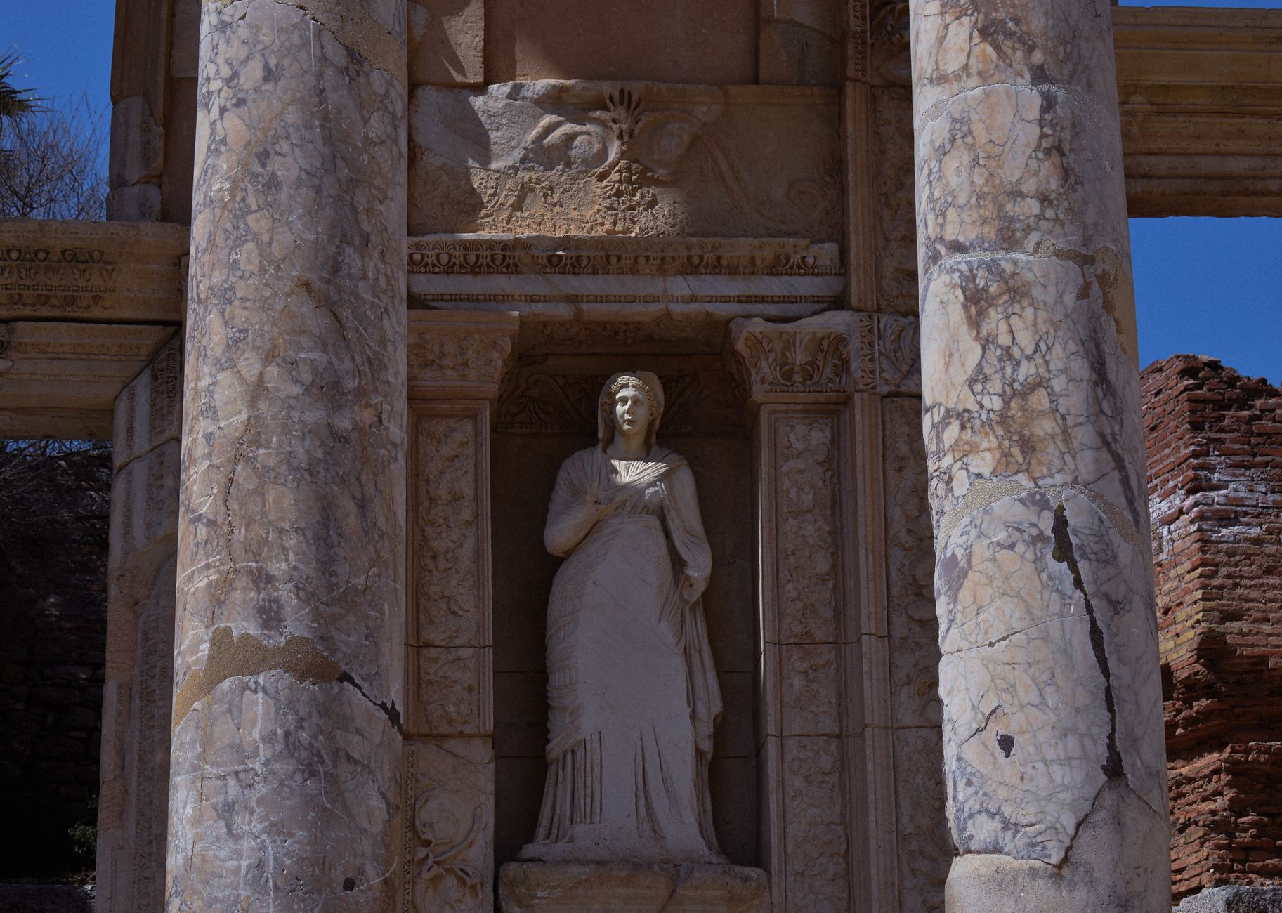 roman marble funerary statue fragments and stone monuments arranged on archaeological excavation site, detailed craftsmanship ancient civilization