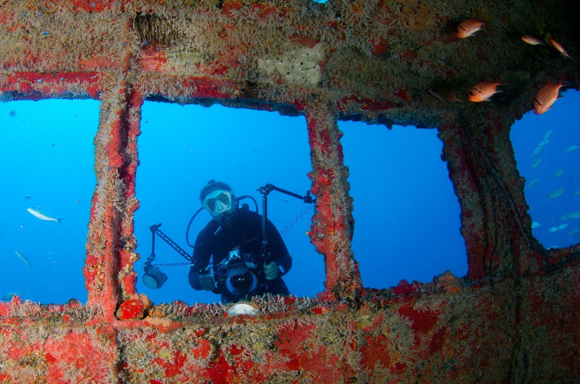 corroded medieval iron helmets underwater archaeology dramatic dark blue light