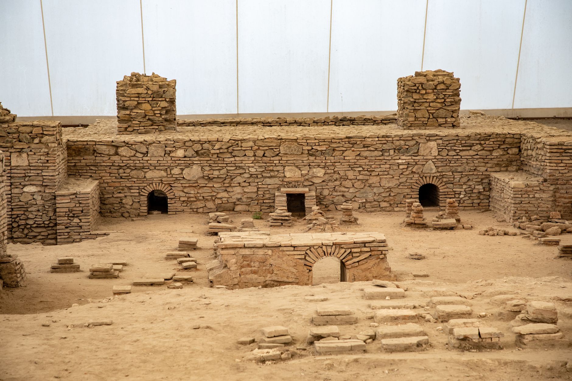 ancient roman bath mosaic excavation site golden afternoon light pyrenees spain