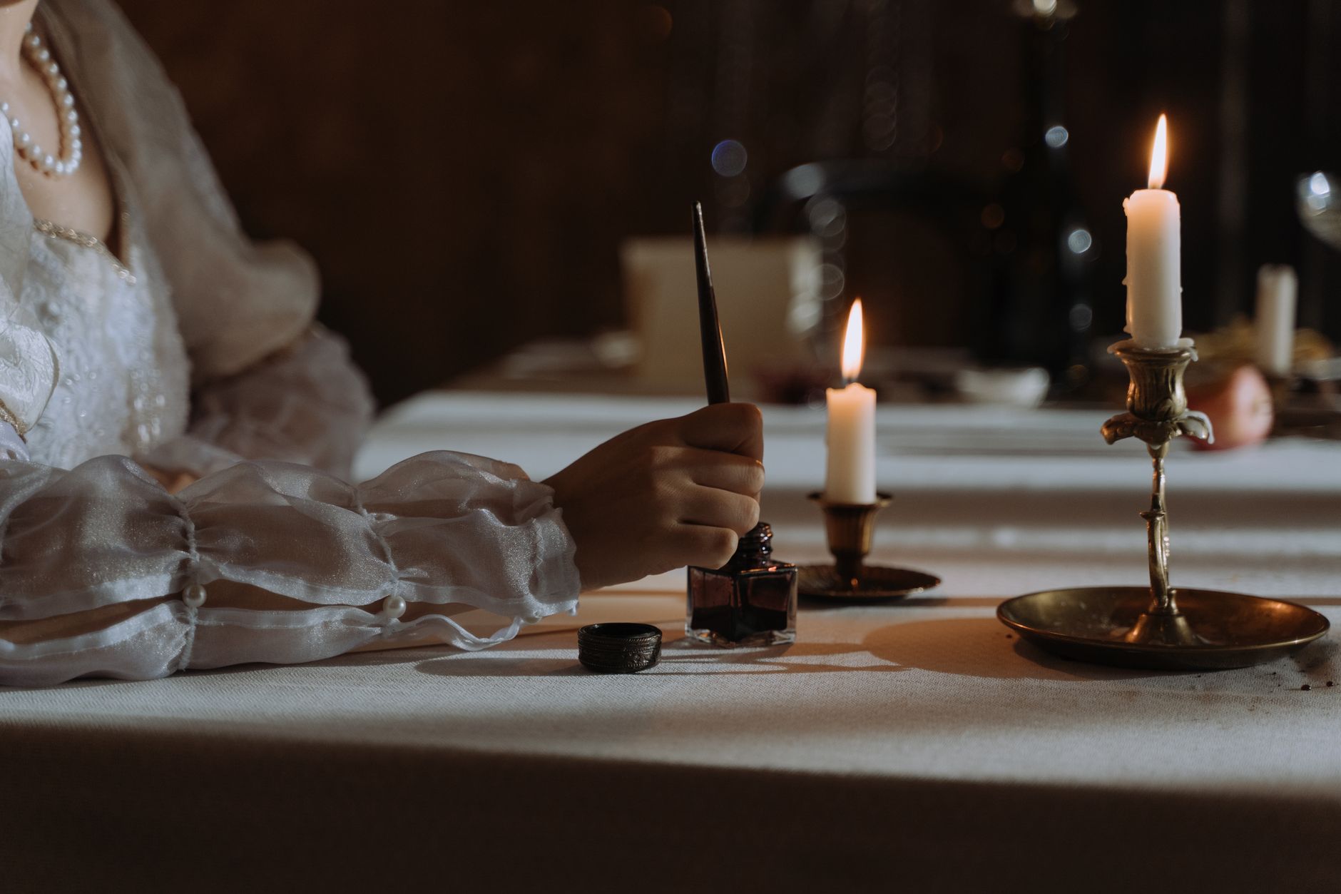 anonymous medieval monk writing manuscript by candlelight in stone scriptorium dramatic light